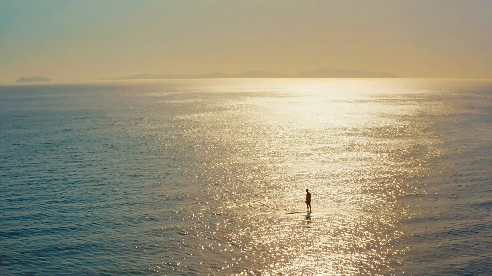 One very small figure at the edge of an ocean that fills the frame